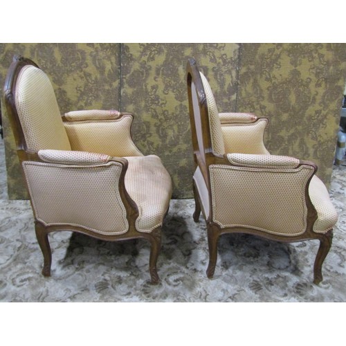 1223 - A pair of upholstered armchairs with carved show wood frames on cabriole supports