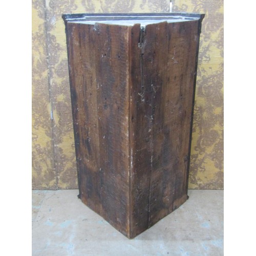 1242 - A Georgian mahogany hanging corner cabinet enclosed by a rectangular astragal glazed panelled door w... 