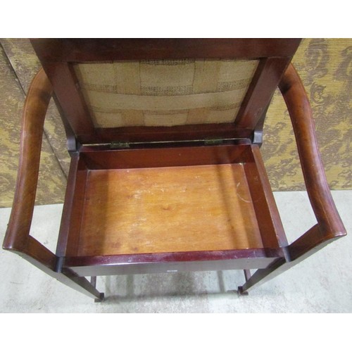 1255 - An inlaid Edwardian mahogany piano stool with hinged upholstered box seat beneath a shaped and mould... 