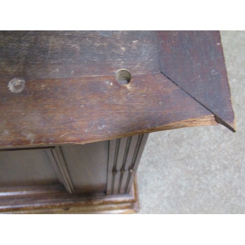 1196 - A small late Victorian mahogany hanging wall cupboard enclosed by a rectangular panelled over a frie... 