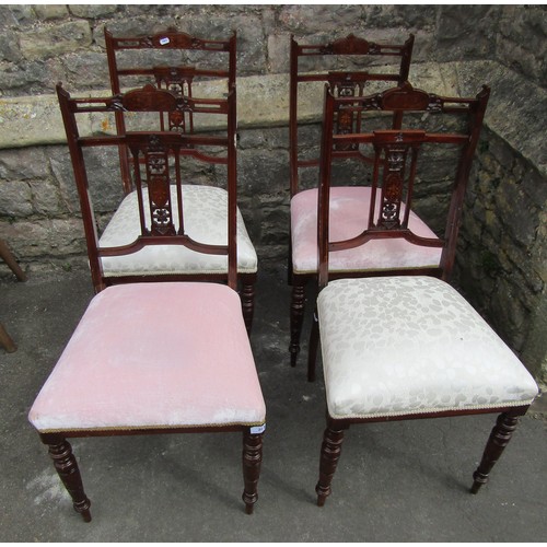 1218 - A set of four inlaid Edwardian mahogany side chairs with carved and pierced marquetry splats on turn... 