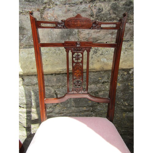 1218 - A set of four inlaid Edwardian mahogany side chairs with carved and pierced marquetry splats on turn... 