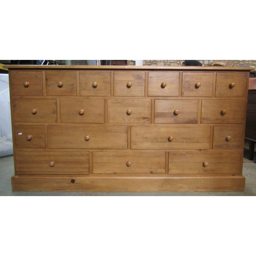 1120 - A traditional pine cabinet containing a series of 19 drawers, 180cm long x 93cm high x 48cm deep app... 