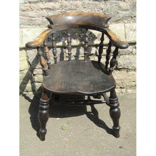 1095 - A Windsor smokers bow elbow chair principally in elm, with turned legs