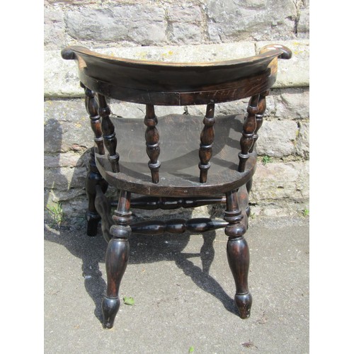 1095 - A Windsor smokers bow elbow chair principally in elm, with turned legs