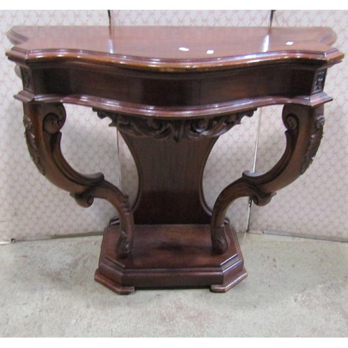 1149 - A mahogany console table on shaped supports, 93cm wide