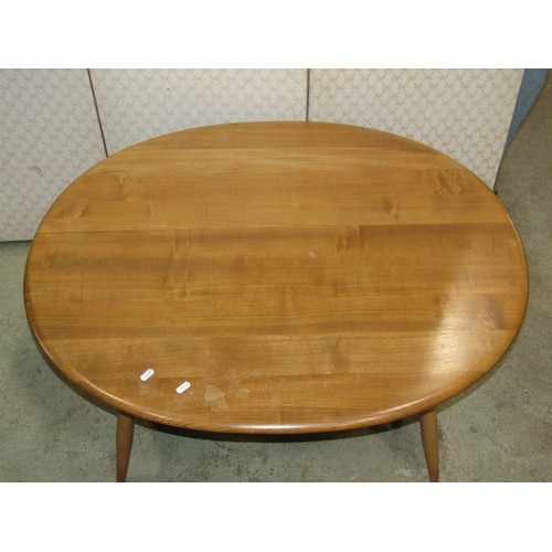 1209 - An Ercol occasional table principally in elm, the oval top 100cm max