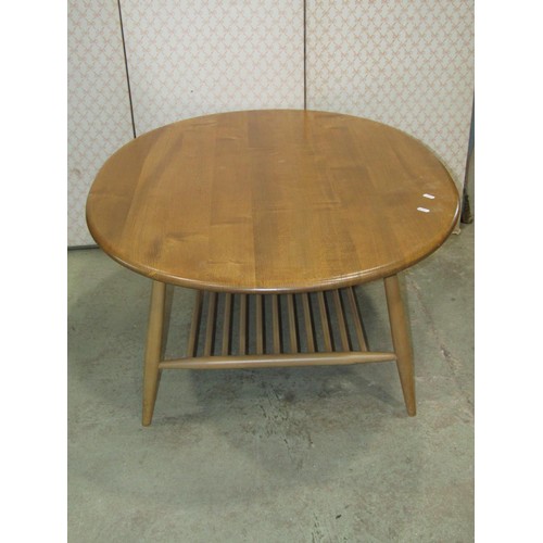 1209 - An Ercol occasional table principally in elm, the oval top 100cm max