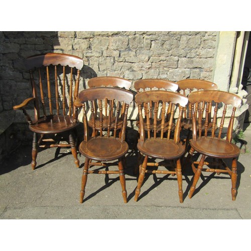 1219 - A set of seven (6+1) Windsor kitchen chairs with turned spindle backs and circular dish seats