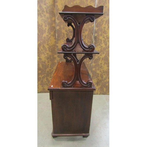 1166 - A Victorian mahogany buffet, the lower section enclosed by a pair of panelled  doors and a frieze dr... 