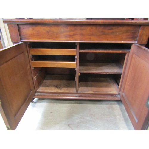 1166 - A Victorian mahogany buffet, the lower section enclosed by a pair of panelled  doors and a frieze dr... 