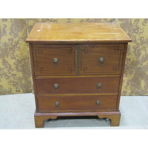 1165 - A Regency mahogany bedside cabinet enclosed by cupboard doors and drawers with lion mask and ring ha... 