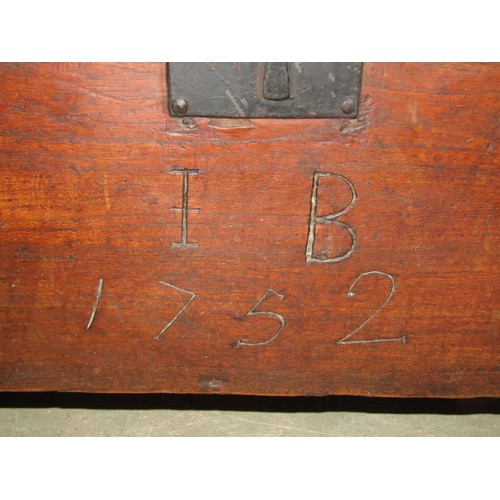 1174 - An 18th century elm six plank coffer, monogrammed I B and dated 1752, 113cm long