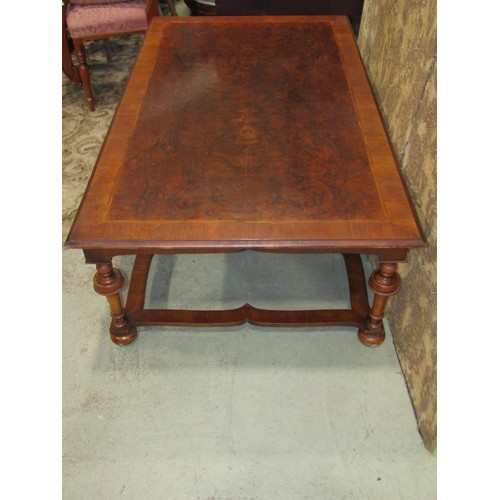 1205 - A Queen Ann style walnut and figured walnut low occasional  table raised on six turned supports with... 