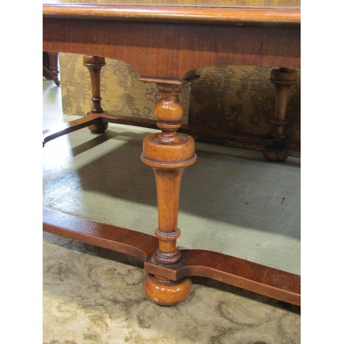 1205 - A Queen Ann style walnut and figured walnut low occasional  table raised on six turned supports with... 