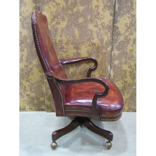 1216 - A library chair in the Georgian style with chestnut coloured leather upholstery within a mahogany fr... 