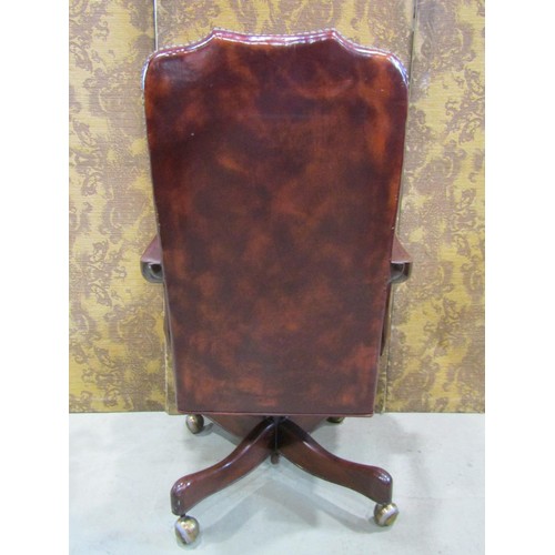 1216 - A library chair in the Georgian style with chestnut coloured leather upholstery within a mahogany fr... 