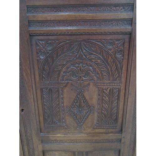 1158 - An old English style carved oak side cupboard in the Elizabethan style with panelled framework and s... 