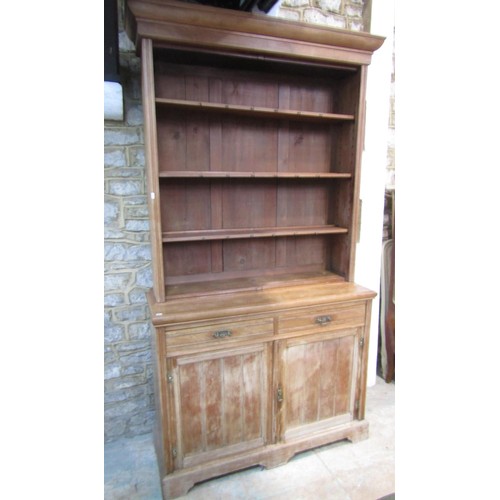 1103 - A 19th  century American walnut dresser enclosed by doors and drawers with plate rack above, 120cm w... 