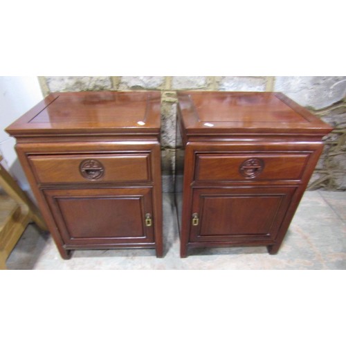 1107 - A pair of Chinese hardwood side cabinets each enclosed by a drawer and door, 61cm high