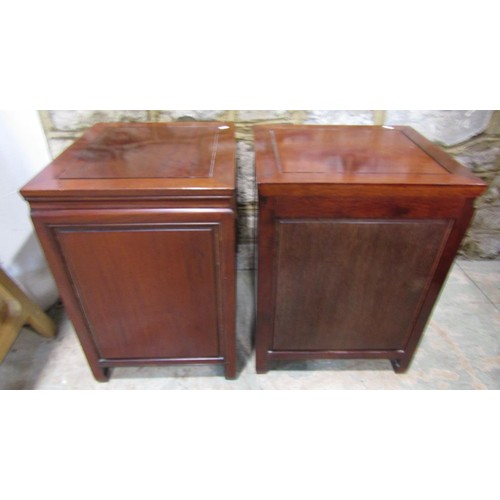 1107 - A pair of Chinese hardwood side cabinets each enclosed by a drawer and door, 61cm high