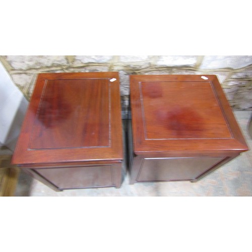 1107 - A pair of Chinese hardwood side cabinets each enclosed by a drawer and door, 61cm high