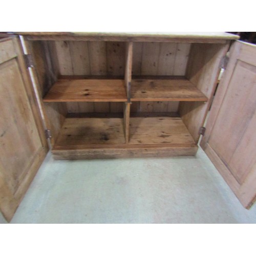 1132 - A stripped pine side cupboard enclosed by two doors