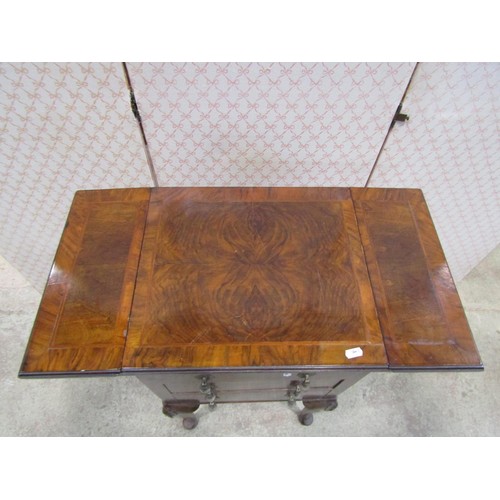 1177 - A walnut drop leaf side table enclosing three drawers on pad feet, 42cm wide when closed