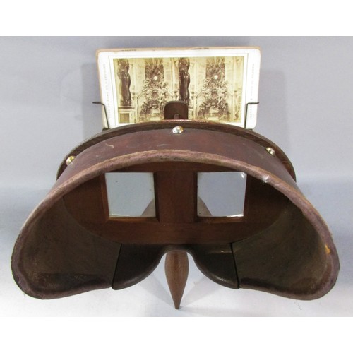 565 - A Victorian Stereoscopic viewer, with a selection of topographical cards, rural landscapes, classica... 