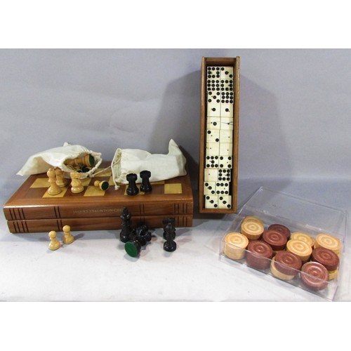 566 - An Antique Nine Dot Domino set in a wooden case, only 53 tiles, a set of wooden draughts counters, a... 