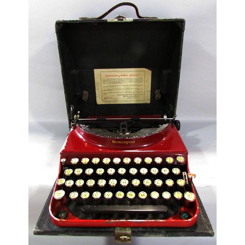 568 - A Remington red painted “World Service” portable typewriter Serial number V.195039, in its  carry ca... 