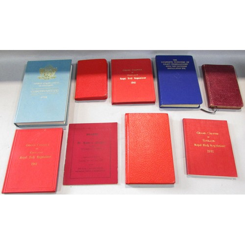 571 - A Masonic lodge case containing aprons, books on regulations, investitures and constitutions,  a pai... 