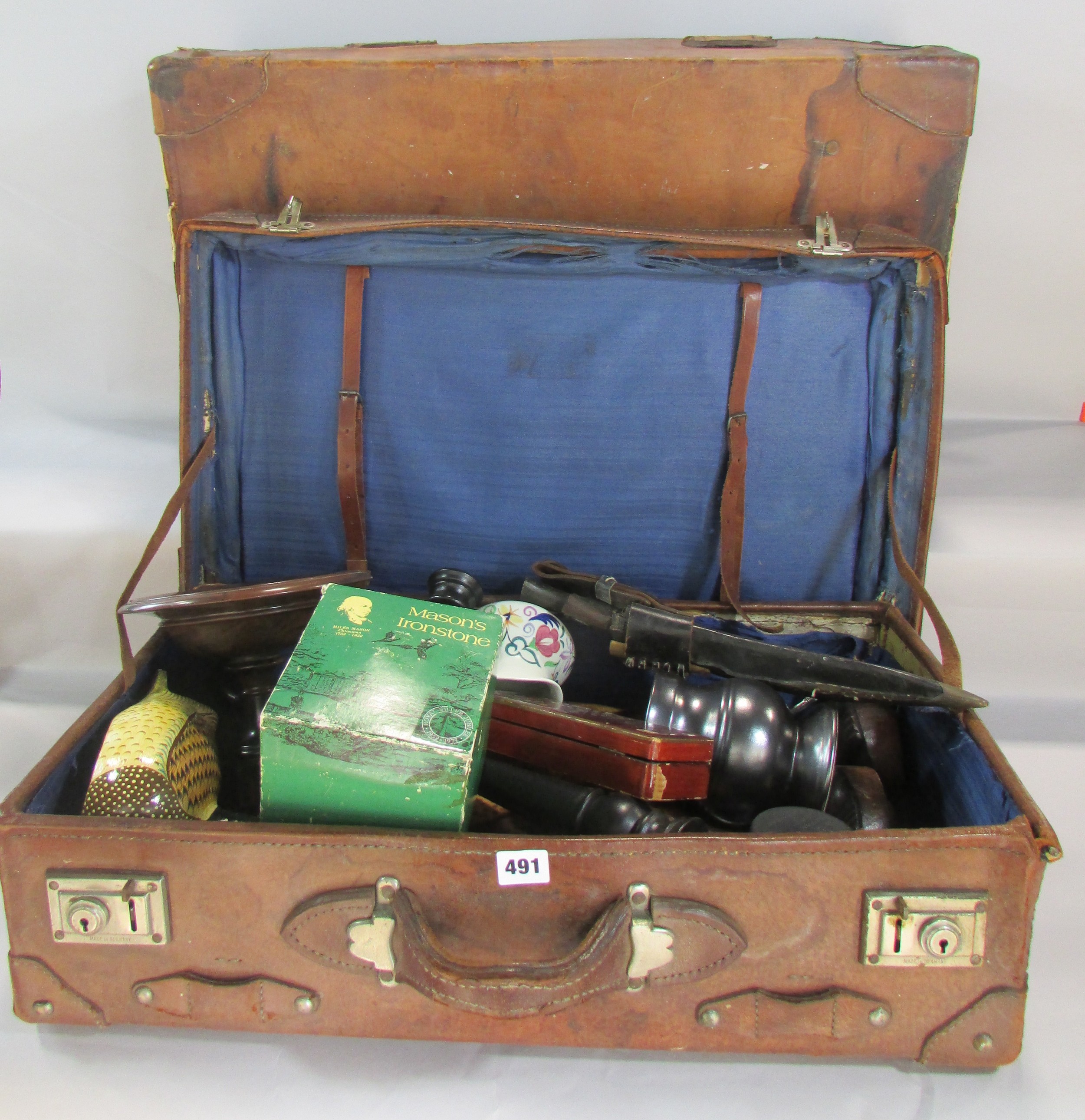 Two vintage battered leather suitcases, containing a miscell...