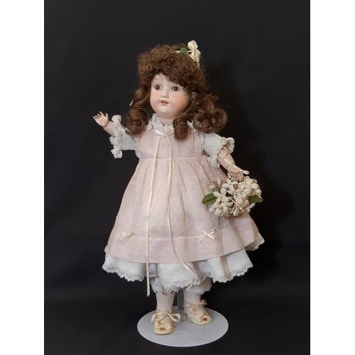 865 - An early 20th century bisque head doll by Armand Marseille with jointed composition body, closing br... 