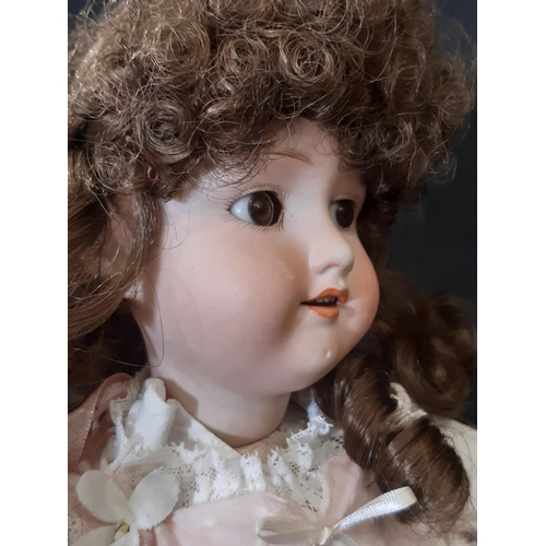 865 - An early 20th century bisque head doll by Armand Marseille with jointed composition body, closing br... 