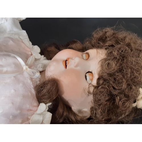 865 - An early 20th century bisque head doll by Armand Marseille with jointed composition body, closing br... 