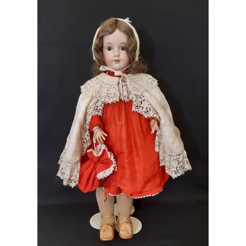 866 - An early 20th century German bisque head doll by Max Oscar Arnold with jointed composition body, clo... 