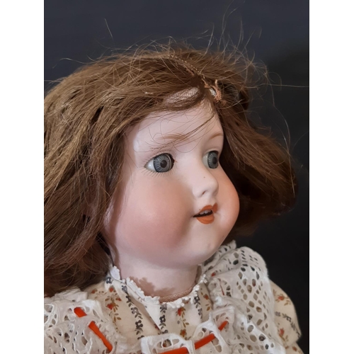 870 - An early 20th century bisque head doll by Armand Marseille with jointed composition body, closing bl... 