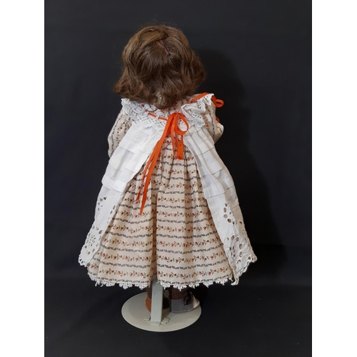 870 - An early 20th century bisque head doll by Armand Marseille with jointed composition body, closing bl... 