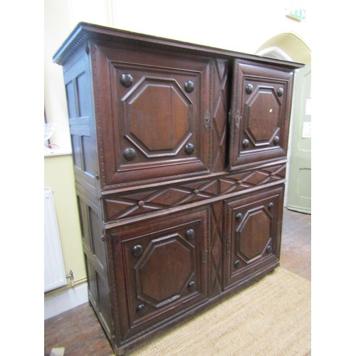 1318 - A 17th/18th century food cupboard the front elevation enclosed by two pairs of panelled doors with r... 