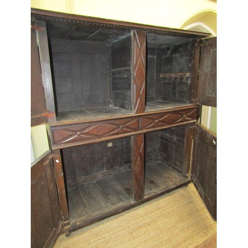 1318 - A 17th/18th century food cupboard the front elevation enclosed by two pairs of panelled doors with r... 