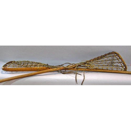 573 - Two Vintage Lacrosse sticks with leather and gut mesh, both 110cm long approximately and two vintage... 