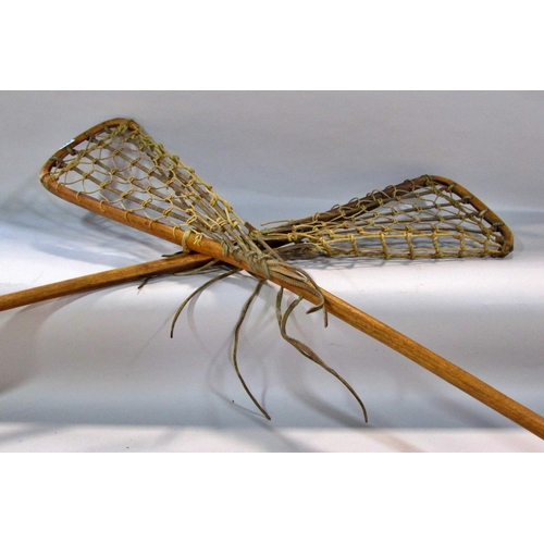 573 - Two Vintage Lacrosse sticks with leather and gut mesh, both 110cm long approximately and two vintage... 