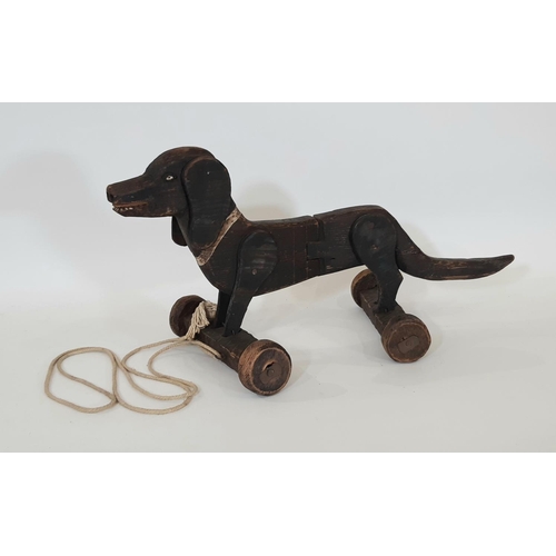 882 - Vintage wooden pull along Dachshund dog toy with moving ears and articulated centre