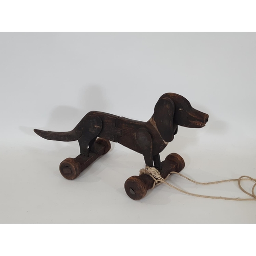 882 - Vintage wooden pull along Dachshund dog toy with moving ears and articulated centre