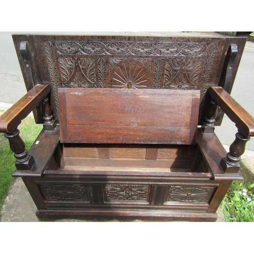 1346 - A late 19th century oak monks bench with geometric carved panels on turned supports, with rising/adj... 