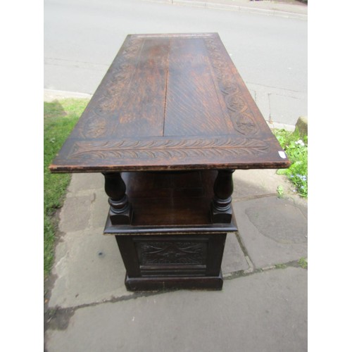 1346 - A late 19th century oak monks bench with geometric carved panels on turned supports, with rising/adj... 