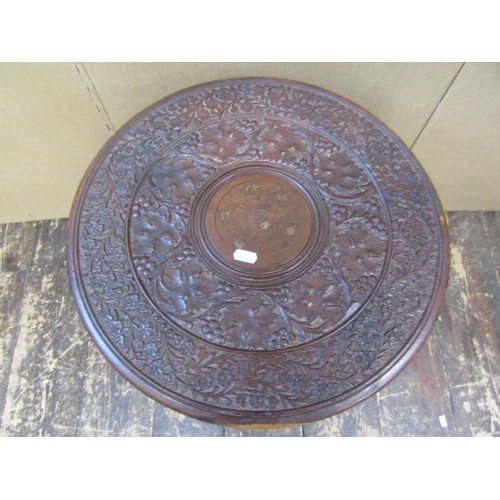 1347 - An Anglo Indian carved occasional table with circular top on a tripod base, with repeating vine leaf... 