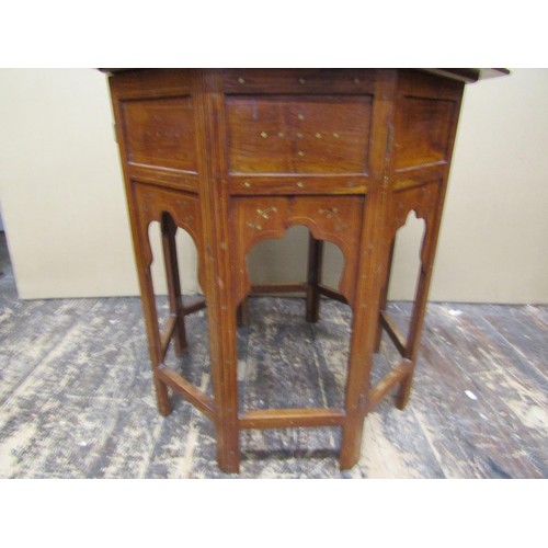 1348 - An Indian hardwood occasional table, the octagonal top with geometric brass inlay detail, raised on ... 