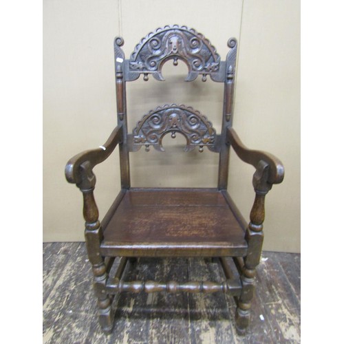 1374 - An antique oak South Yorkshire elbow chair of traditional form with carved and arched ladder back, s... 